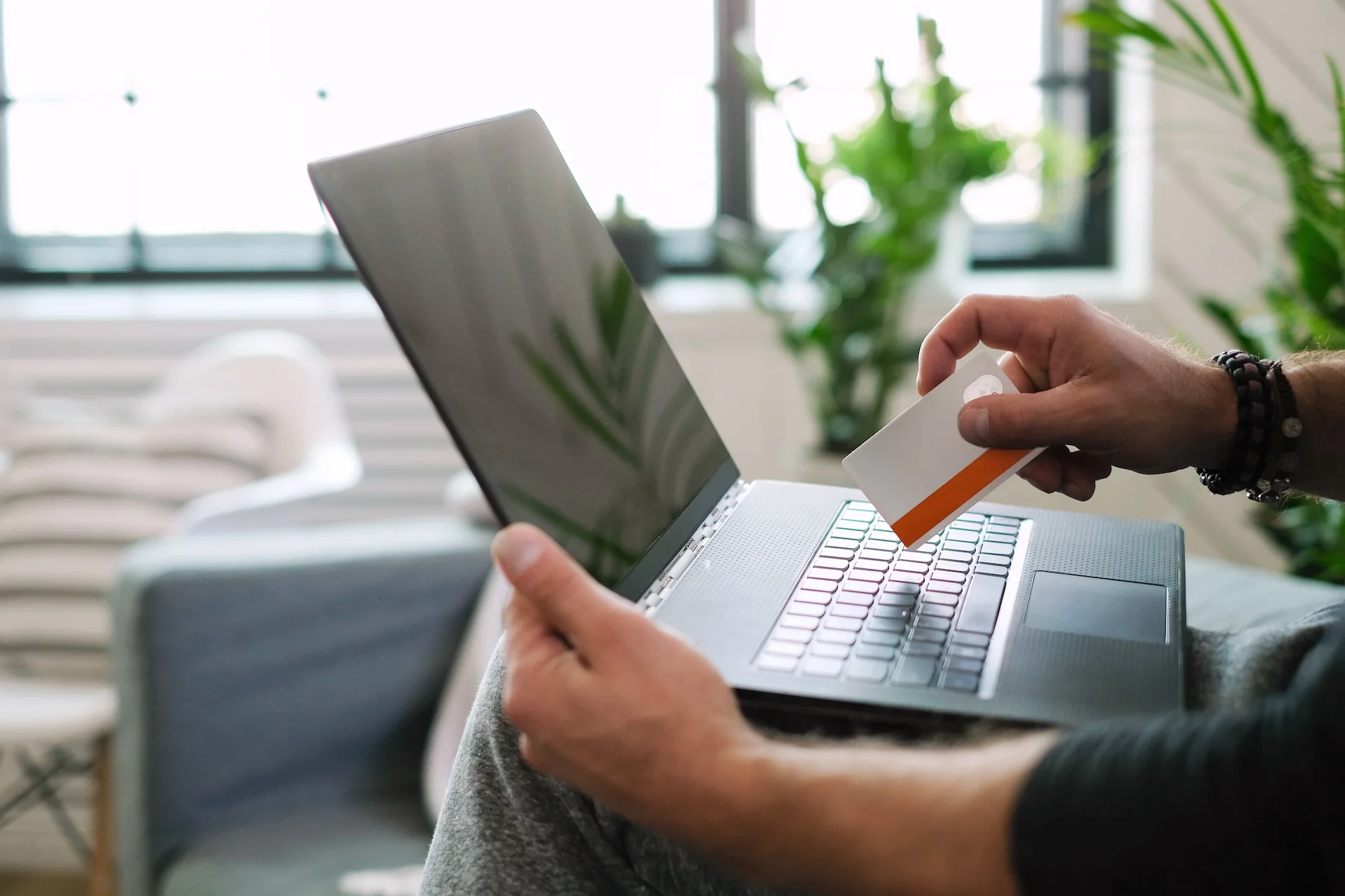 man with a card and laptop