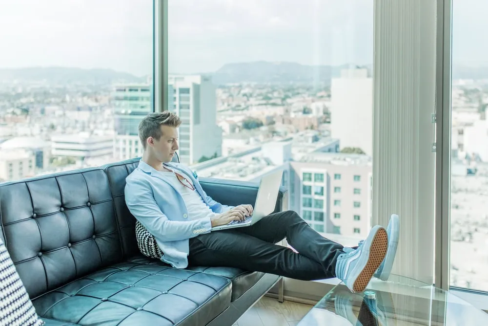 Man with laptop sitting in the sofa