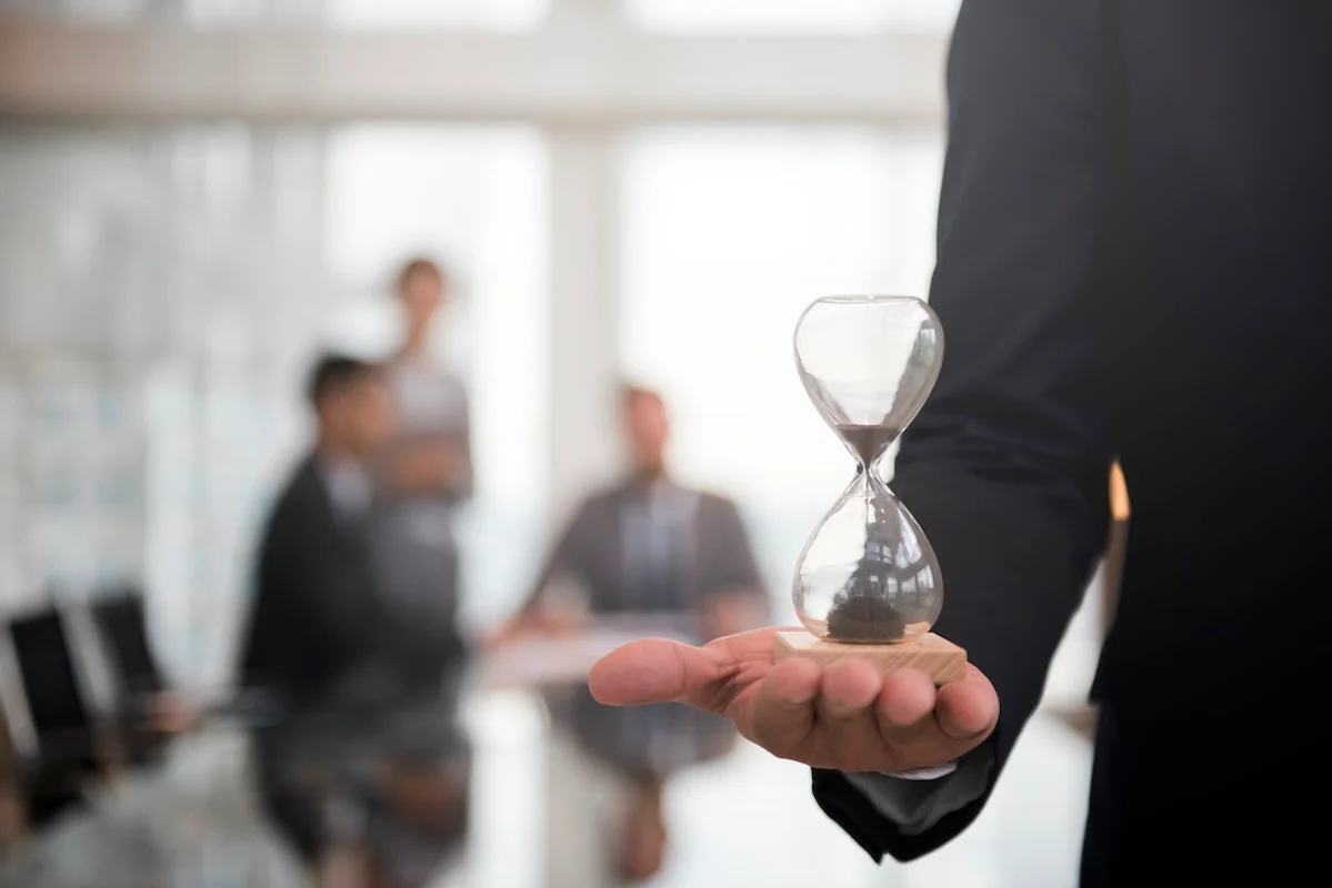 businessman holding hourglass