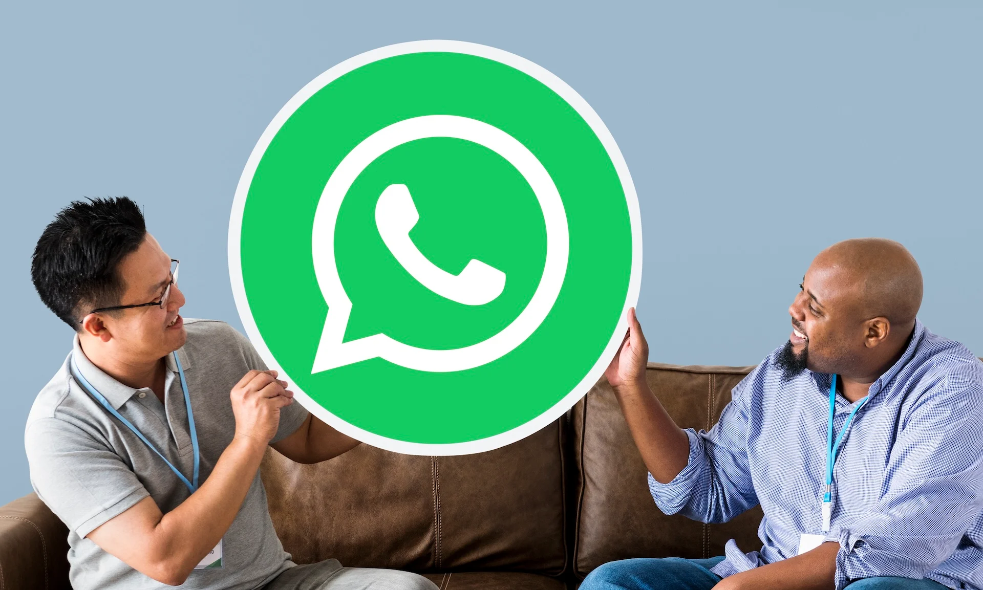 men showing whatsapp  logo