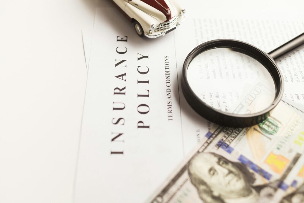 Close-up of short-term rental insurance policy with magnifying glass and US currency